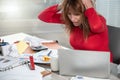 Overworked businesswoman sitting at a messy desk Royalty Free Stock Photo