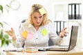 Overworked businesswoman working in office and looking at stickers reminder notes Royalty Free Stock Photo