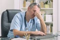 Overworked doctor in his office Royalty Free Stock Photo