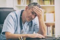 Overworked doctor in his office Royalty Free Stock Photo