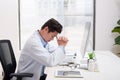 Overworked doctor sitting in his office Royalty Free Stock Photo