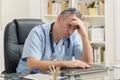 Overworked doctor in his office Royalty Free Stock Photo