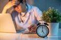 Overworked doctor sitting with laptop in hospital clinic