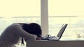 Overworked, Exhausted and tired young businesswoman removes glasses, resting, sleeping over a laptop in a desk at work Royalty Free Stock Photo