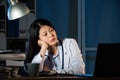 Overworked female doctor sitting beside desk