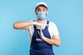 Overworked handyman in overalls and gloves showing time out gesture, need break. Profession of service industry Royalty Free Stock Photo