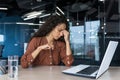 Overworked hispanic business woman working inside modern office building, female worker removed Royalty Free Stock Photo