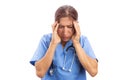 Overworked hospital nurse suffering headache and holding temples