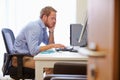 Overworked Male Doctor In Office Sitting At Computer Royalty Free Stock Photo