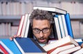 overworked man student reading book in a book store or school library. literature teacher in school with book. knowledge