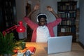 Overwhelmed tired young African man remote worker feeling tired sitting in front of computer all day Royalty Free Stock Photo