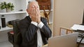 Overworked senior man feeling stressed, working on laptop at office Royalty Free Stock Photo