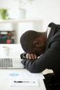 Overworked African American having nap at workplace Royalty Free Stock Photo