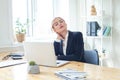 Overworked stressed businesswoman suffering from headache and thinking how to end work Royalty Free Stock Photo