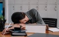Overworked tired businesswoman sleeping on table in office. Young exhausted girl working from home. Woman using laptop Royalty Free Stock Photo