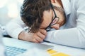 Overworked, tired and man sleeping on desk with burnout, fatigue and business employee with glasses, papers and laptop