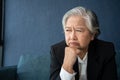 Overworked tired old lady holding head feeling headache. Asian senior business woman stress from hard work. Frustrated business Royalty Free Stock Photo