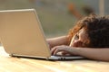 Overworked tired woman resting over a laptop