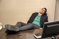 Overworked, tired young businessman sleeping at