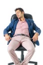 Overworked, tired young businessman sleeping on