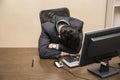 Overworked, tired young businessman sleeping in office