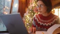 overworked woman freelancer working in xmass decorated coffee shop on Christmas Eve using laptop and notebook. remote