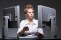 Overworked woman sitting at computers