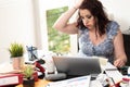 Overworked businesswoman sitting at a messy desk Royalty Free Stock Photo