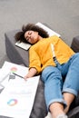 overworked young woman sleeping on couch after work Royalty Free Stock Photo