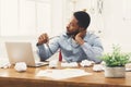 Overworking african-american employee at workplace