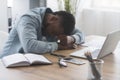 Exhausted black businessman napping at workplace in office Royalty Free Stock Photo