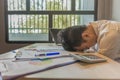 Overworking man laying head on messy documents at workplace Royalty Free Stock Photo