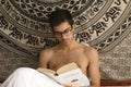 Oviedo, Aturias. Spain - 29 Agost 2018. Portrait of a young normal man shirtless reading the book The long goodbye in Royalty Free Stock Photo