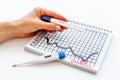 Ovulation home test in female hand over calendar with red mark