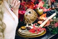 Owl on the festive wedding table with red autumn leaves. Wedding decoration. Artwork Royalty Free Stock Photo