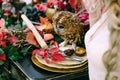 Owl on the festive wedding table with red autumn leaves. Wedding decoration. Artwork Royalty Free Stock Photo