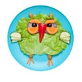 Owl made of fresh vegetables on blue plate Royalty Free Stock Photo