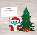 Owl in Santa Claus costume against the background of a Christmas