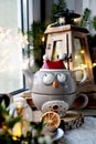 Owl shaped teapot and Christmas decors on window sill