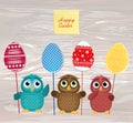 Owls keep Easter decorated eggs on a stick. Multicolored. Empty