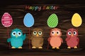 Owls keep Easter decorated eggs on a stick. Multicolored. Vector