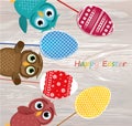 Owls keep Easter decorated eggs on a stick. Multicolored. Vector