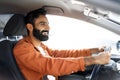 Proud Indian Driver Guy Driving Luxury Automobile, Posing In Vehicle