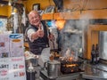 Owner chef of Izakaya Toyo in Osaka, Japan use his flame thrower to cook food Royalty Free Stock Photo