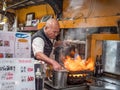 Owner chef of Izakaya Toyo in Osaka, Japan use his flame thrower to cook food Royalty Free Stock Photo