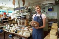 Owner Of Delicatessen Standing In Shop Holding Loaf Royalty Free Stock Photo