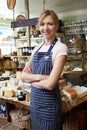 Owner Of Delicatessen Standing In Shop Royalty Free Stock Photo