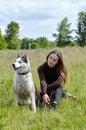 Owner girl playing with her siberian husky at field Royalty Free Stock Photo