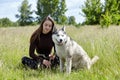 Owner girl playing with her siberian husky at field Royalty Free Stock Photo