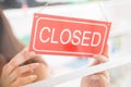 Owner Holding Closed Sign In Clothing Store Royalty Free Stock Photo